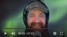 Andy Neely's bearded, smiling, headphone-wearing face.